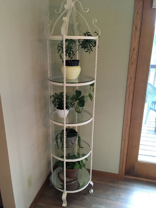 Painted metal corner shelving unit with round glass shelves & twisted metal supports. 