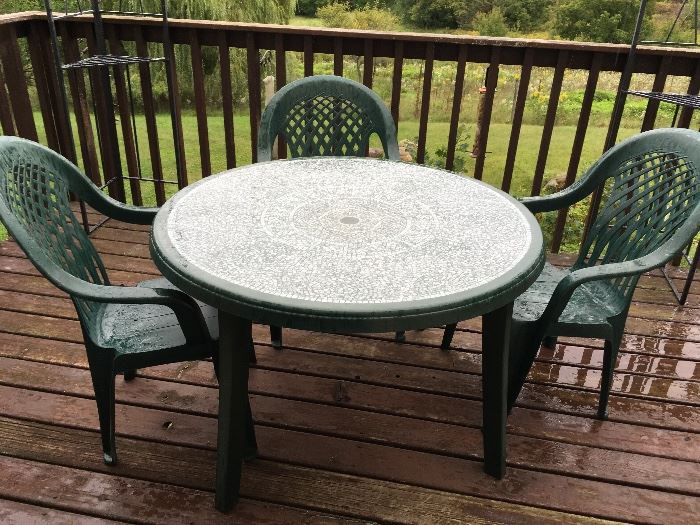 Plastic outdoor dining set. Photo shows 3 chairs, but there are 4