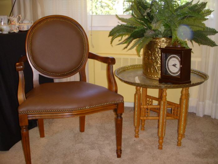 Medallion back chair. Table has a carved, inlaid wood base and a hammered brass tray top