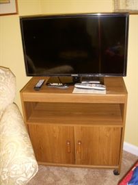 Flat screen TV on an oak grain cabinet