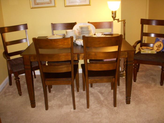 Dining set.  Table with 4 side chairs, and two added captain's chairs.  Table has self-storing leaf.  This set is like new