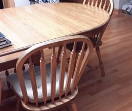 solid oak dining table with 8 chairs and 4 leaves, this is a very large trestle table 