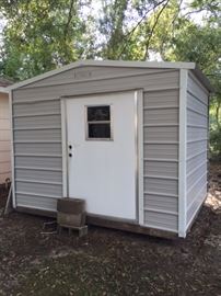 metal outbuilding-- 8'2" deep, 10'2" wide, 8'3" tall (to bottom of wooden runners)