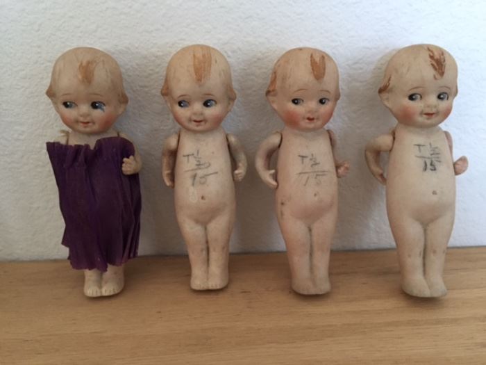 4 kewpie dolls