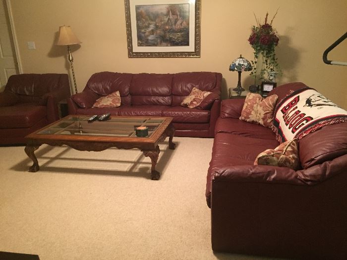 Matching leather sofas, chair and ottoman. Coffee table