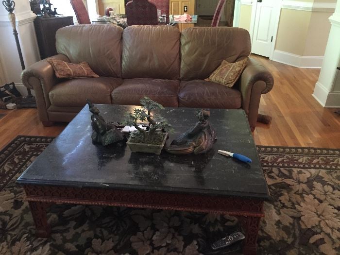 Leather couch. Marble topped coffee table