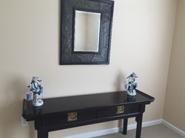 Sofa table, mirror, figurines.
