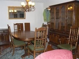 American Drew Dining Room Suite.  The table measures 44x67 without the leaf.  There are two leaves that are 14 inches with pads included.  There are 6 chairs plus two captains chairs. Includes a buffet and a dry sink server on wheels with cooper top.  It has duck tail drawers!!