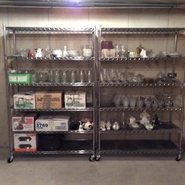many smalls including bar ware, dishes and appliances new in the box. All of this on professional rolling shelves