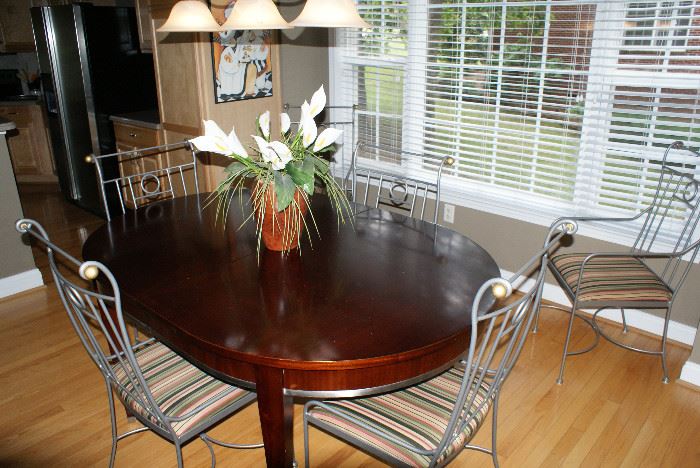Beautiful wood table with metal trim and 6 Charleston Forge iron chairs
