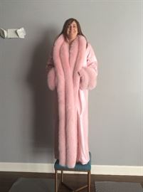 Full length bubblegum pink lambskin coat with full wrap and deep cuffs of dyed fox. Rhinestone enhanced collar and cuffs. Size 16