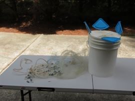 Bait bucket and casting net.