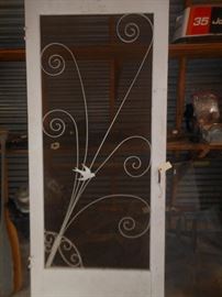 Scrollwork screen door with bird