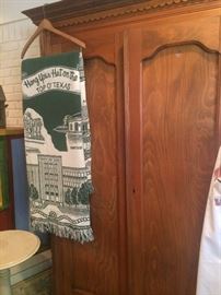 Large entertainment cabinet ---- filled with games; green & white "Top O' Texas" throw