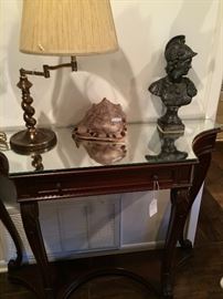 Two-shelf entry table; large shell; warrior bust