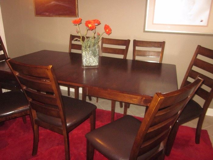 Kitchen table  with 8 chairs and 1 leaf. Leaf is in, in this picture.