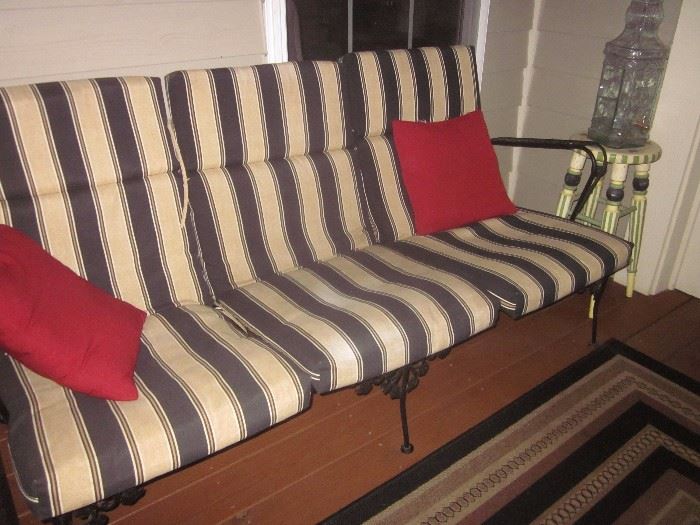 Wrought iron patio sofa, matching chairs and tables 