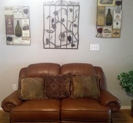 leather tan nail head love seat, wall hangings