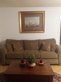 fabric 3-cushion sofa, coffee table, rug, print