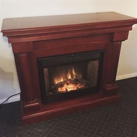 Large hardwood electric fireplace/heater. In very good working condition.