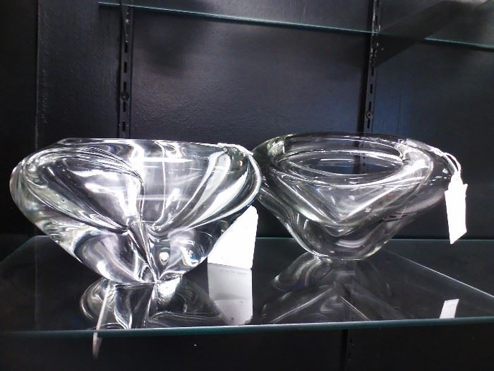 These modern crystal bowls will electrify any shelf or table they adorn. Each captures the light nearby and reflects it as you can see from this photo. Smooth and artistic, they range in size from approximately 4-1/2" to 5-1/2" H x 6" W x 9 to 10-1/2" L. The bowl on the right is divided, while the other is not. 