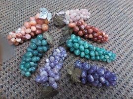 Hungry? Don't eat these grapes! They're actually polished stones coiled together to make a strand of grapes held together with a metal leaf. This is one piece of fruit that will last ages.