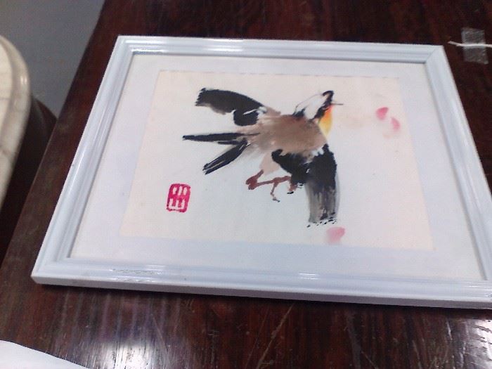 This Japanese watercolor is sure to migrate to someone's home.  This bird taking flight is done in hues of black, brown and a little orange. The paper measures approx. 7-1/2" x 6" with a mat and frame surrounding it. 
