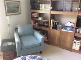 Contemporary upholstered armchair in teal with ebony frame, MCM wall unit