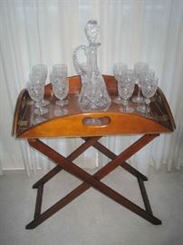 Wooden butler tray table with large crystal decanter and 14 wine goblets 