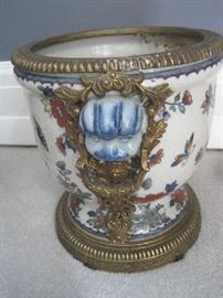 Side of cache pot with brass trim