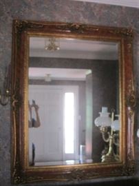 Beveled glass large hall mirror in gold frame with dark red trim 