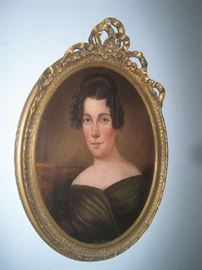 Gold gilt framed oval picture of a lady with ribbon decoration on top of frame 