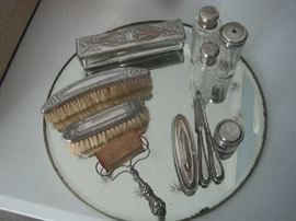 Sterling brushes, bottles, nail accessories on vintage mirror plateau 