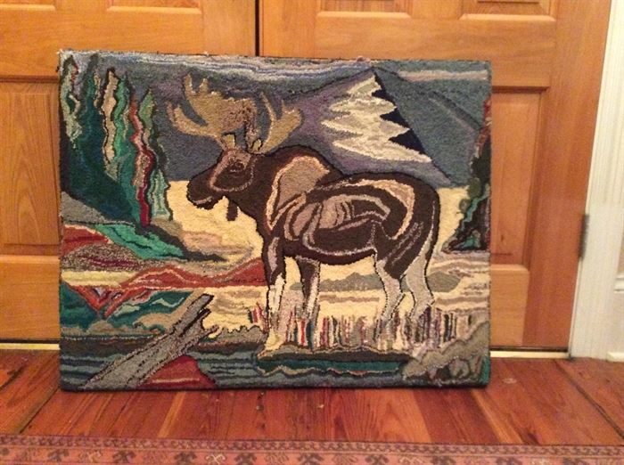 American hooked rug of a moose standing in a stream. 