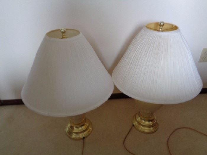 Golden and Ivory matching lamps
-Two ivory and gold lamps -Gold base -Ivory vase style -White lamp shades: 27"H