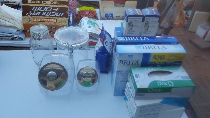 A number of Brita water filter pitchers and filter refills.  Some neat glass canisters and jars.