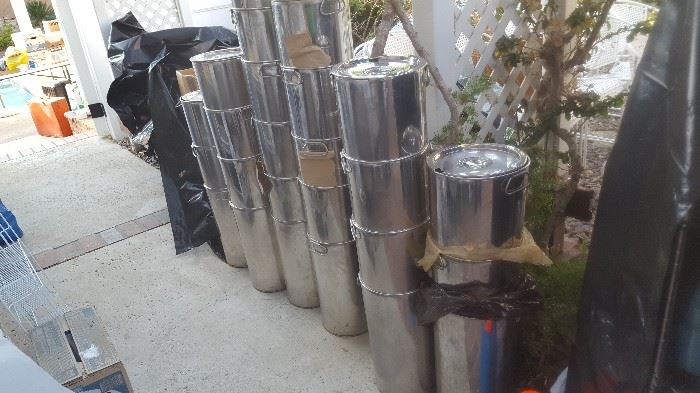 Stainless restaurant tall food containers with lids.