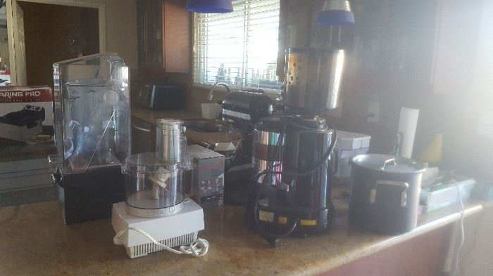 Commercial Vitamixes and coffee maker that stores and grinds the beans for each pot.  Cuisinart Food Processor Kitchen Aid Mixers and special attachments.