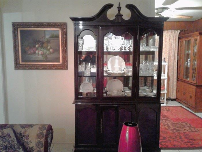 Beautiful dark mahogany Chippendale China cabinet that lights up with glass shelves.