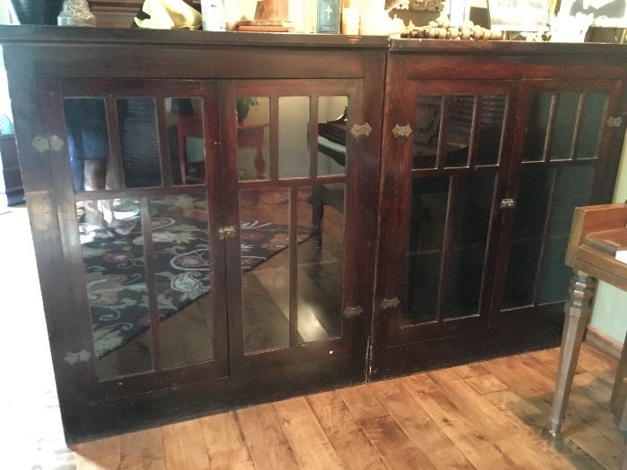 Mahogany glass door cabinets, set of 2, with original glass and hardware. Ends are finished for exposure, as well as the back. Great for book, dishes, photos, what knots, etc. Shelves could be replaced with glass and lighting installed in the top. Rare find. Additional photos available, email seller. Each piece measures 43"W x 49"H x 11"D  Total width 86"W