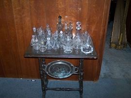 GLASS CRUETS ON AN ANTIQUE TABLE
