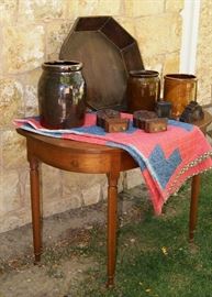 Demi-lune cherry table, primitive quilt, dovetailed wood bowl, various crocks and wood carved trim