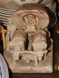 Carved stone covered wagon with oxen