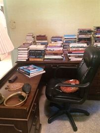 L-shaped desk; office chair; some more of the many books