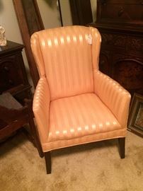 Small peach colored wing back chair