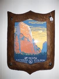 Arts & Crafts Movement hammered copper shield-shaped frame with vintage travel poster inside