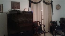 Wooden rocking chairs, big screen TV, drapes, Wall decor, DVD/VCR combo