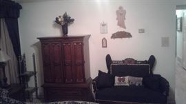 cushioned love seat, wall decor, wooden closet 