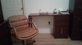 Wooden desk, office supplies, cushioned/rolling chair