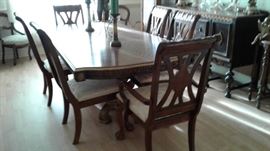 beautiful wooden dining table with 6 cushioned chairs